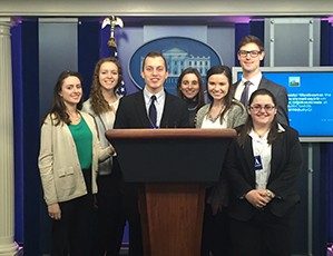 Students at the White House press briefing room's podium