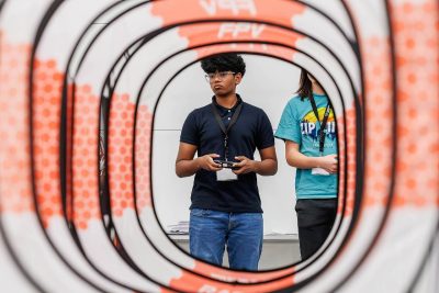 a student holds drone controls 