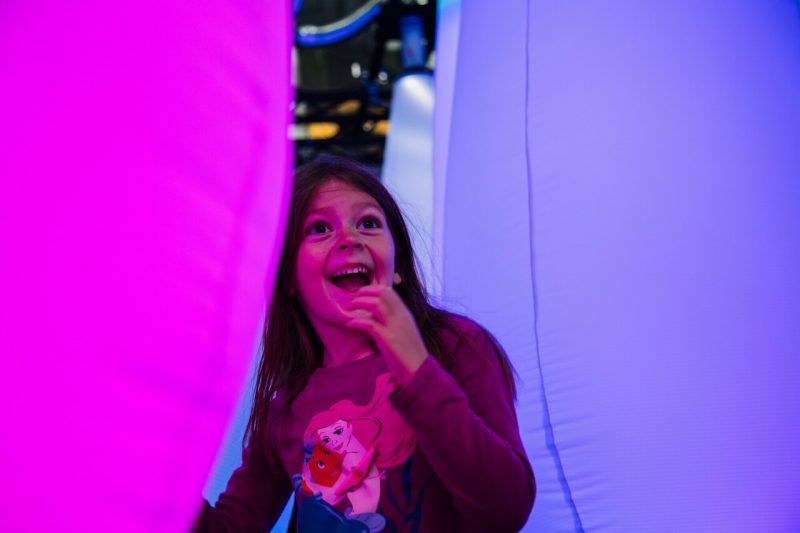 A child smiling in the Celestial Garden exhibit