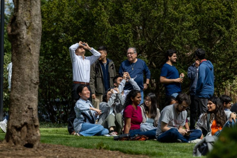 April 8th, 2024-Students, faculty, and staff watch the solar eclipse at the Northern Virginia Center (NVC). (photo by Craig Newcomb/Virginia Tech)