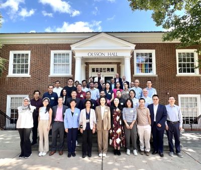 Group of 50 Virginia researchers standing in front of a building at the University of Virginia. 